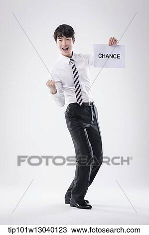 Stock Image - a business man with a paper saying change. Fotosearch