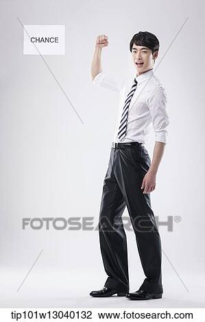 Stock Image - a business man with a paper saying change. Fotosearch