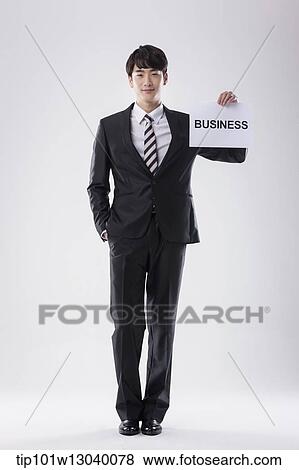 a business man with a paper saying business View Large Photo Image Stock Photo - a business man with a paper saying business. Fotosearch