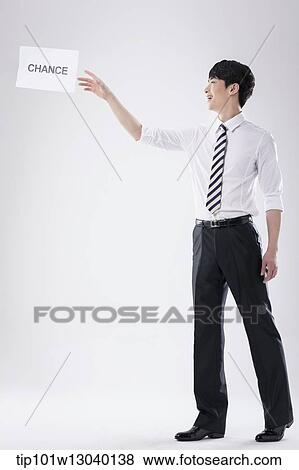 Stock Photo - a business man with a paper saying change. Fotosearch