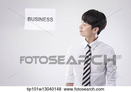 Stock Photo - a business man with a paper saying business. Fotosearch
