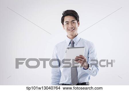 Picture - a business man with a tablet. Fotosearch