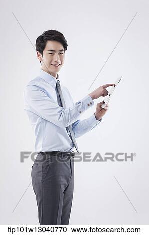 a business man with a tablet View Large Photo Image Stock Image - a business man with a tablet. Fotosearch