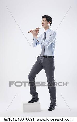 Stock Image - a business man with a telescope. Fotosearch