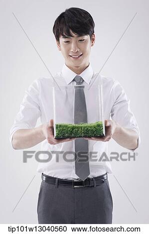 a business man with a transparent box of grass View Large Photo Image Stock Image - a business man with a transparent box of grass. Fotosearch