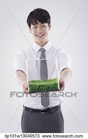 a business man with a transparent box of grass View Large Photo Image Stock Image - a business man with a transparent box of grass. Fotosearch