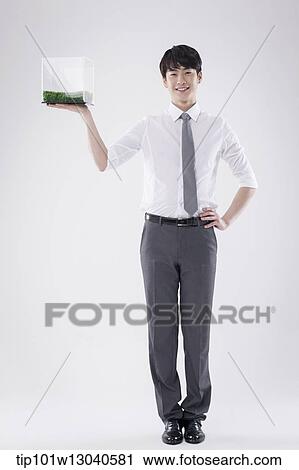 a business man with a transparent box of grass View Large Photo Image Stock Image - a business man with a transparent box of grass. Fotosearch