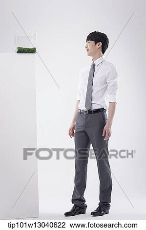 a business man with a transparent box of grass View Large Photo Image Stock Image - a business man with a transparent box of grass. Fotosearch