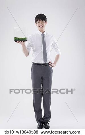 a business man with a transparent box of grass View Large Photo Image Stock Photo - a business man with a transparent box of grass. Fotosearch
