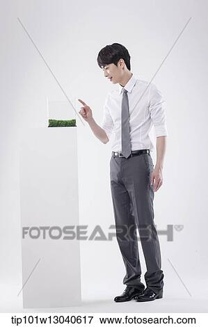 a business man with a transparent box of grass View Large Photo Image Stock Photo - a business man with a transparent box of grass. Fotosearch