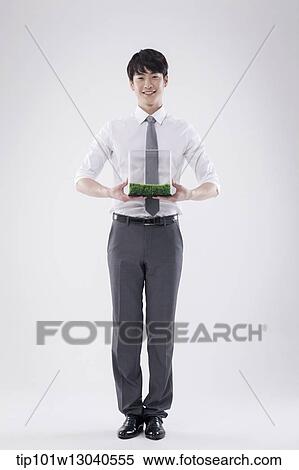 a business man with a transparent box of grass View Large Photo Image Stock Photography - a business man with a transparent box of grass. Fotosearch