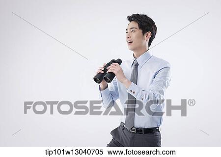 Stock Photography - a business man with binoculars. Fotosearch