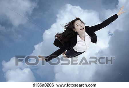 Stock Photograph - a business woman flying. Fotosearch