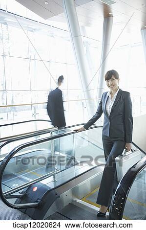 Picture - a business woman going up the stairs. Fotosearch