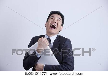 Stock Image - a businessman happily hugging a laptop. Fotosearch