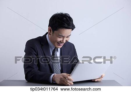 a businessman holding a laptop View Large Photo Image Picture - a businessman holding a laptop. Fotosearch
