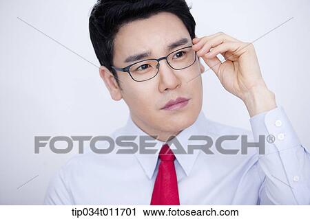 Stock Image - a businessman in business suit looking serious. Fotosearch