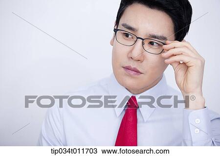 Stock Image - a businessman in business suit looking serious. Fotosearch