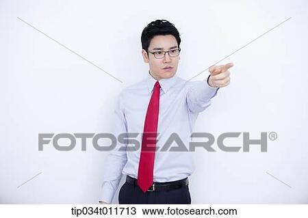 Stock Image - a businessman in business suit pointing somewhere. Fotosearch