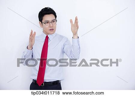 Stock Photo - a businessman in business suit explaining using hand gesture. Fotosearch