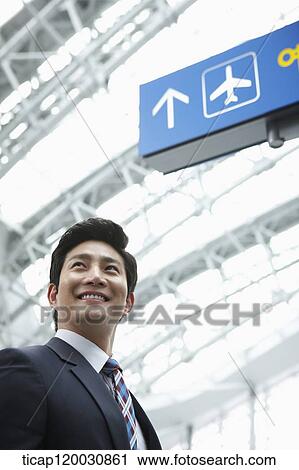 Stock Image - a businessman in the airport. Fotosearch
