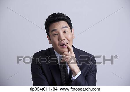Picture - a businessman looking confused. Fotosearch