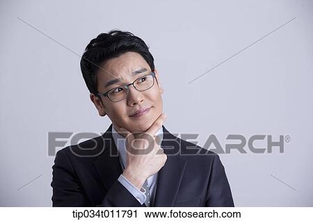 Stock Image - a businessman looking confused. Fotosearch