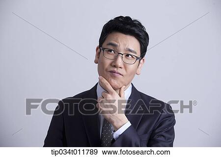 Stock Photo - a businessman looking confused. Fotosearch