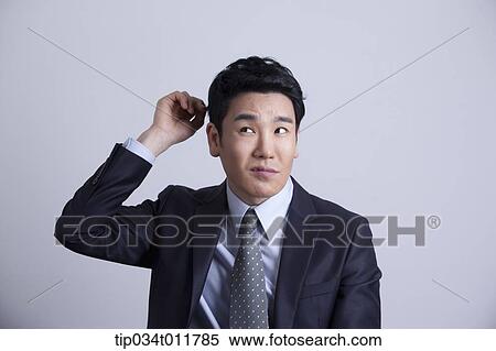 a businessman looking confused View Large Photo Image Stock Photography - a businessman looking confused. Fotosearch