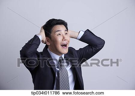 Stock Photograph - a businessman looking stressed. Fotosearch