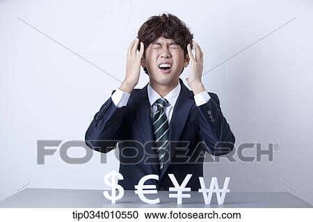 a businessman looking stressed with currency blocks View Large Photo Image Stock Image - a businessman looking stressed with currency blocks. Fotosearch