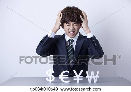 a businessman looking stressed with currency blocks View Large Photo Image Stock Photo - a businessman looking stressed with currency blocks. Fotosearch
