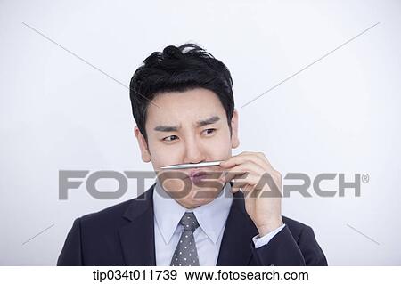 Stock Photo - a businessman playing with a pen. Fotosearch