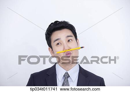 a businessman playing with a pencil View Large Photo Image Stock Image - a businessman playing with a pencil. Fotosearch