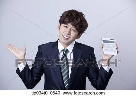 a businessman using a calculator View Large Photo Image Stock Image - a businessman using a calculator. Fotosearch