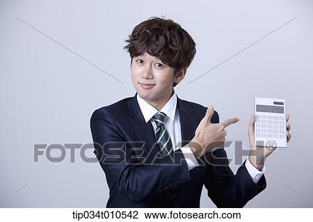 a businessman using a calculator View Large Photo Image Stock Image - a businessman using a calculator. Fotosearch