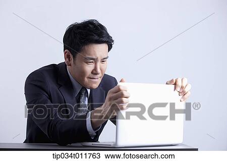 a businessman using a laptop View Large Photo Image Stock Image - a businessman using a laptop. Fotosearch