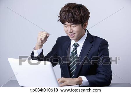 Stock Photo - a businessman using a laptop. Fotosearch