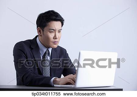 a businessman using a laptop View Large Photo Image Stock Photography - a businessman using a laptop. Fotosearch