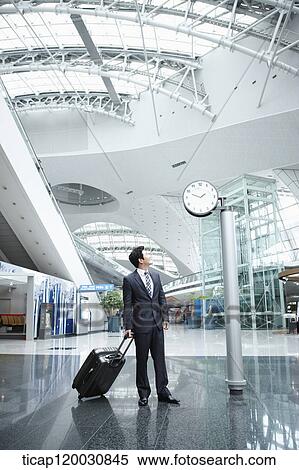 Stock Photography - a businessman with a suitcase in the airport. Fotosearch