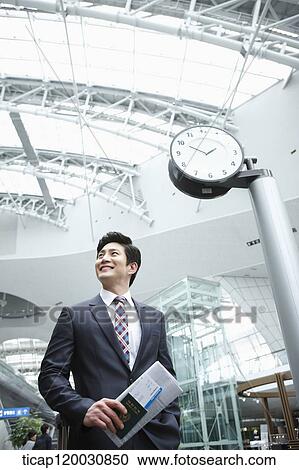 a businessman with passport and boarding pass in the airport View Large Photo Image Stock Image - a businessman with passport and boarding pass in the airport. Fotosearch