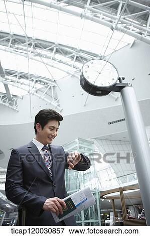 a businessman with passport and boarding pass in the airport View Large Photo Image Stock Photo - a businessman with passport and boarding pass in the airport. Fotosearch