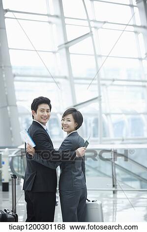 a businesswoman and businessman hugging each other in the airport View Large Photo Image Stock Photo - a businesswoman and businessman hugging each other in the airport. Fotosearch