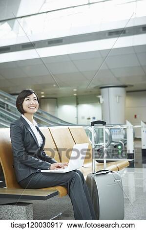 a businesswoman using laptop in the airport View Large Photo Image Stock Photo - a businesswoman using laptop in the airport. Fotosearch
