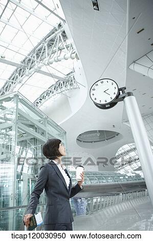a businesswoman walking with a suitcase in the airport View Large Photo Image Stock Image - a businesswoman walking with a suitcase in the airport. Fotosearch