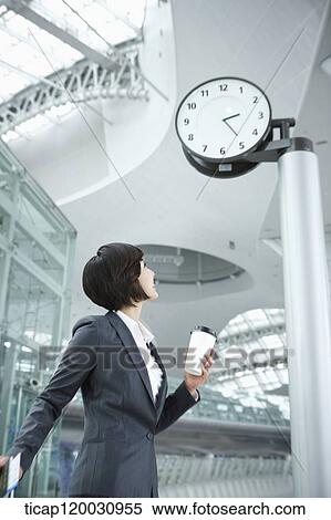 a businesswoman walking with a suitcase in the airport View Large Photo Image Stock Photography - a businesswoman walking with a suitcase in the airport. Fotosearch