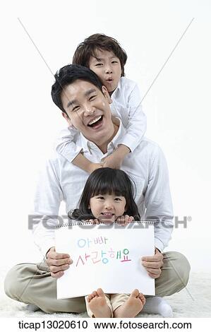 a daughter sitting in fathers lap and holding a notebook View Large Photo Image Stock Image - a daughter sitting in fathers lap and holding a notebook. Fotosearch