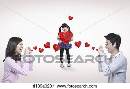 a family with heart shaped balloons View Large Photo Image Stock Photo - a family with heart shaped balloons. Fotosearch