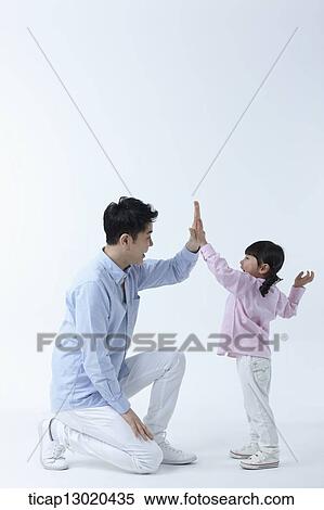 a father and a daughter doing high five View Large Photo Image Stock Photography - a father and a daughter doing high five. Fotosearch