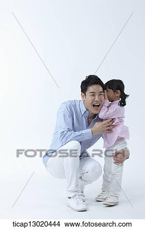 Picture - a father and a daughter hugging. Fotosearch